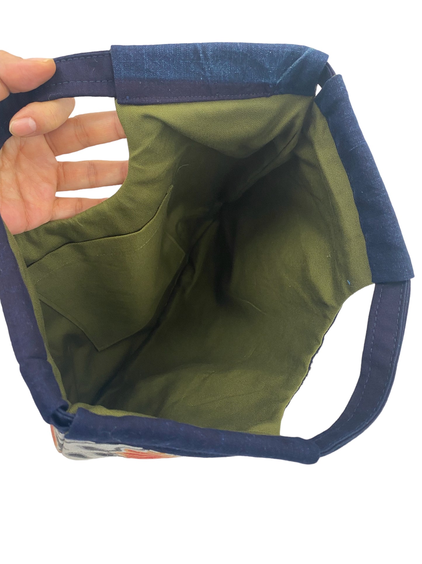 Handbags made of MUSHANOBORI fabric with unique hand-stitched shapes.