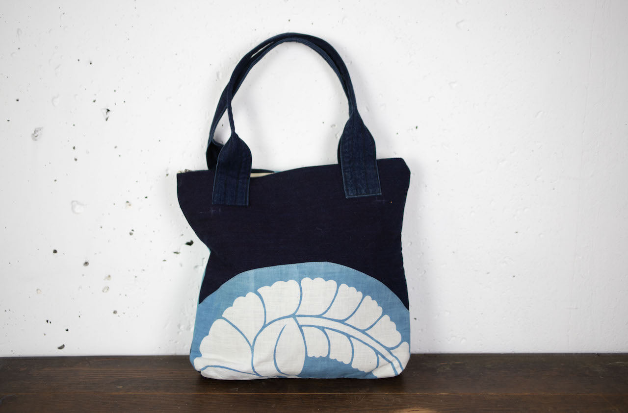 Indigo-dyed hand-stitched handbags made of old cloth with family crests and kanji characters.