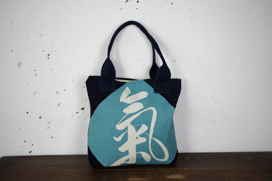 Indigo-dyed hand-stitched handbags made of old cloth with family crests and kanji characters.