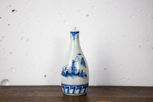 Lidded sake bottle with landscape painting.