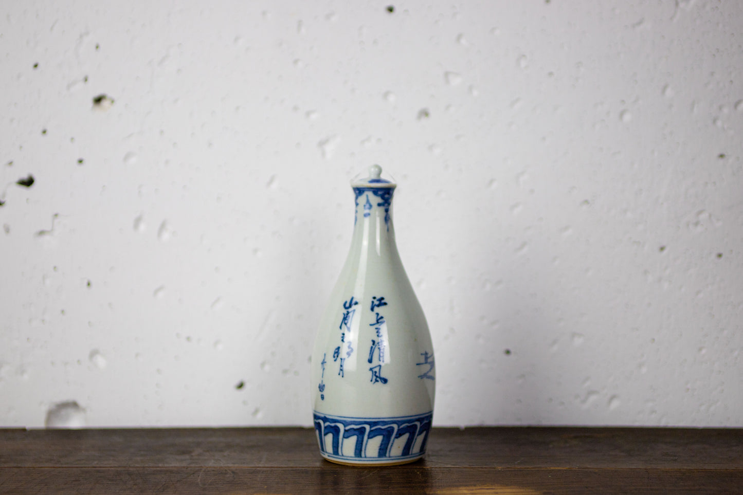 Lidded sake bottle with landscape painting.