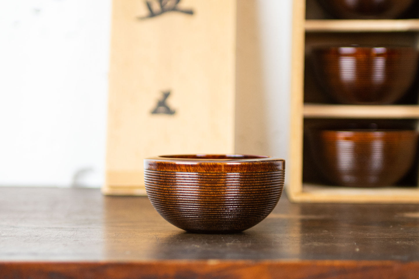 Set of 5 wooden vessels in wooden box.